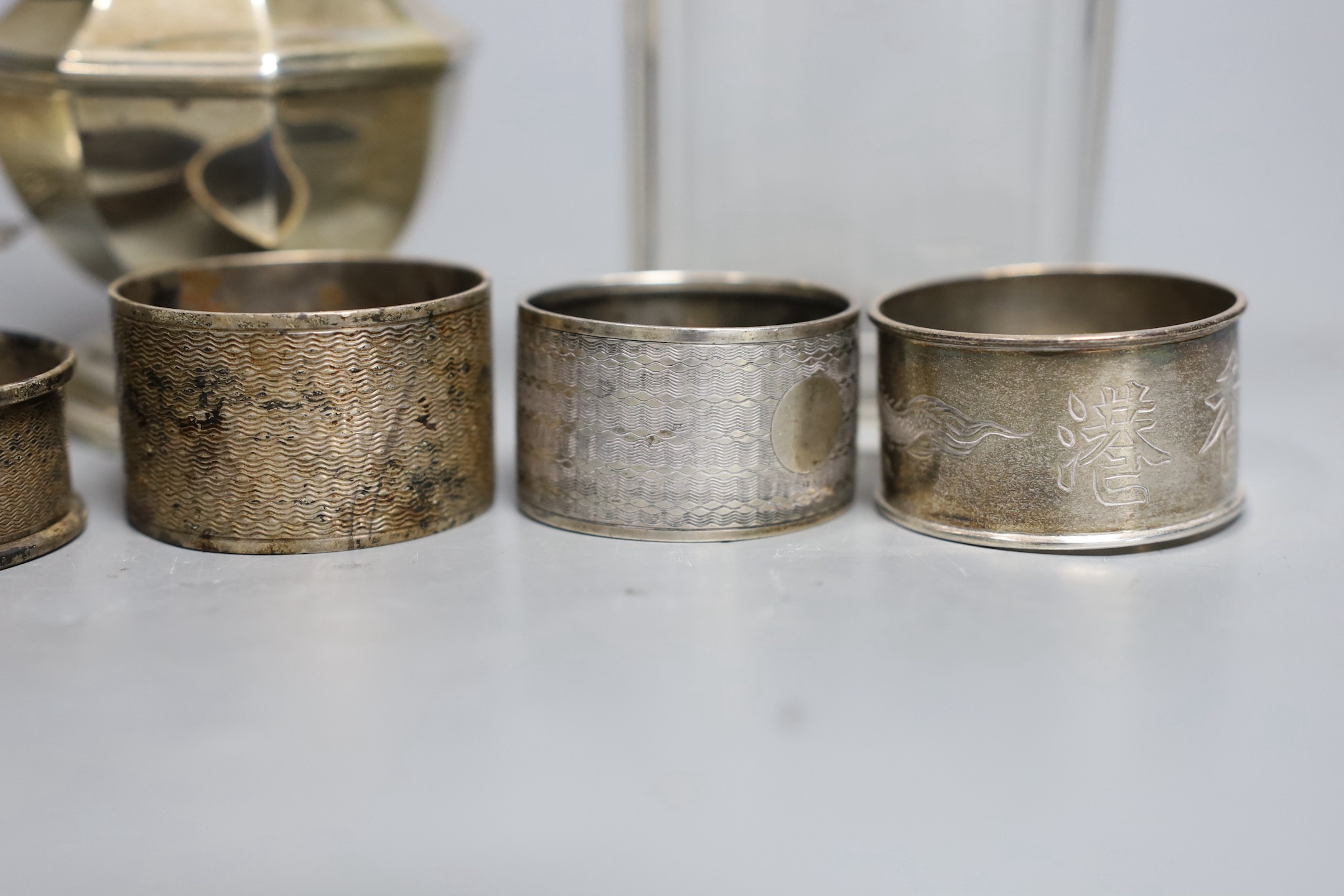 A George V silver sugar caster, London, 1933, 17cm, a silver topped glass toilet jar, a silver bon bon dish and five silver serviette rings.